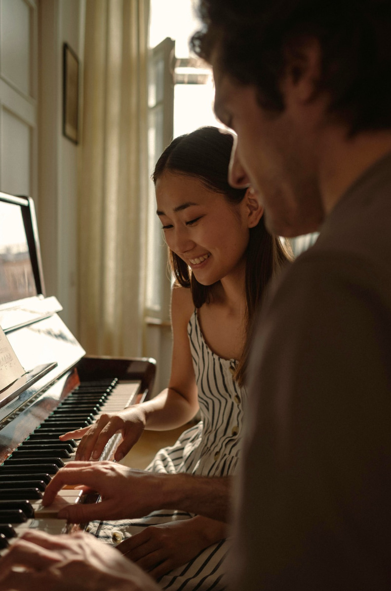 Girl learning piano during music lessons